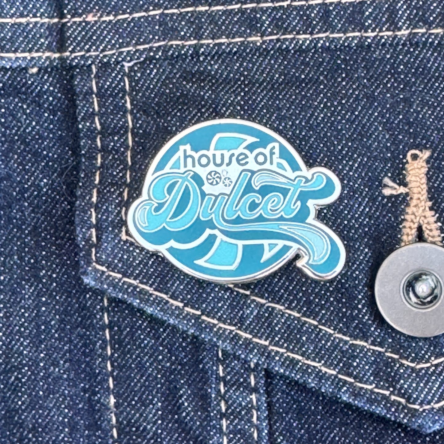 House of Dulcet logo pin in blue and white for fans of drag.