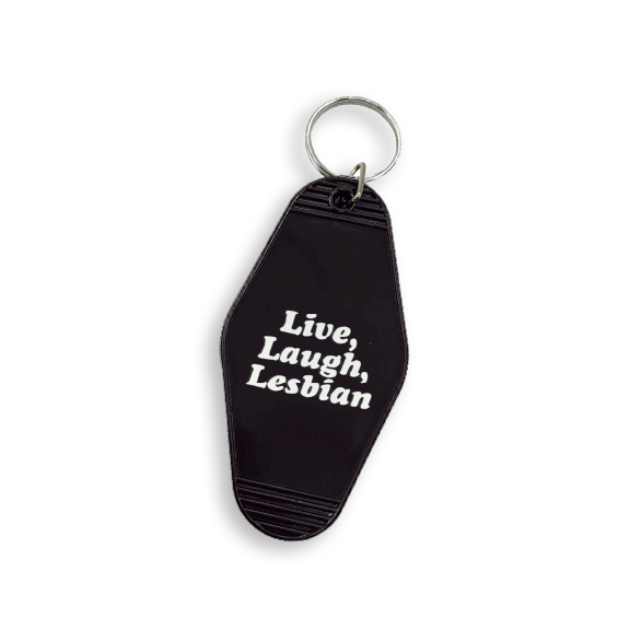 Black vintage-style hotel key tag with white text that reads: Live, Laugh, Lesbian.