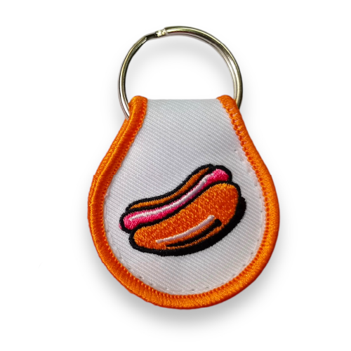 Quirky key tag designed by a recognized Vancouver designer, embroidered with an orange border and a fun orange and red hotdog.