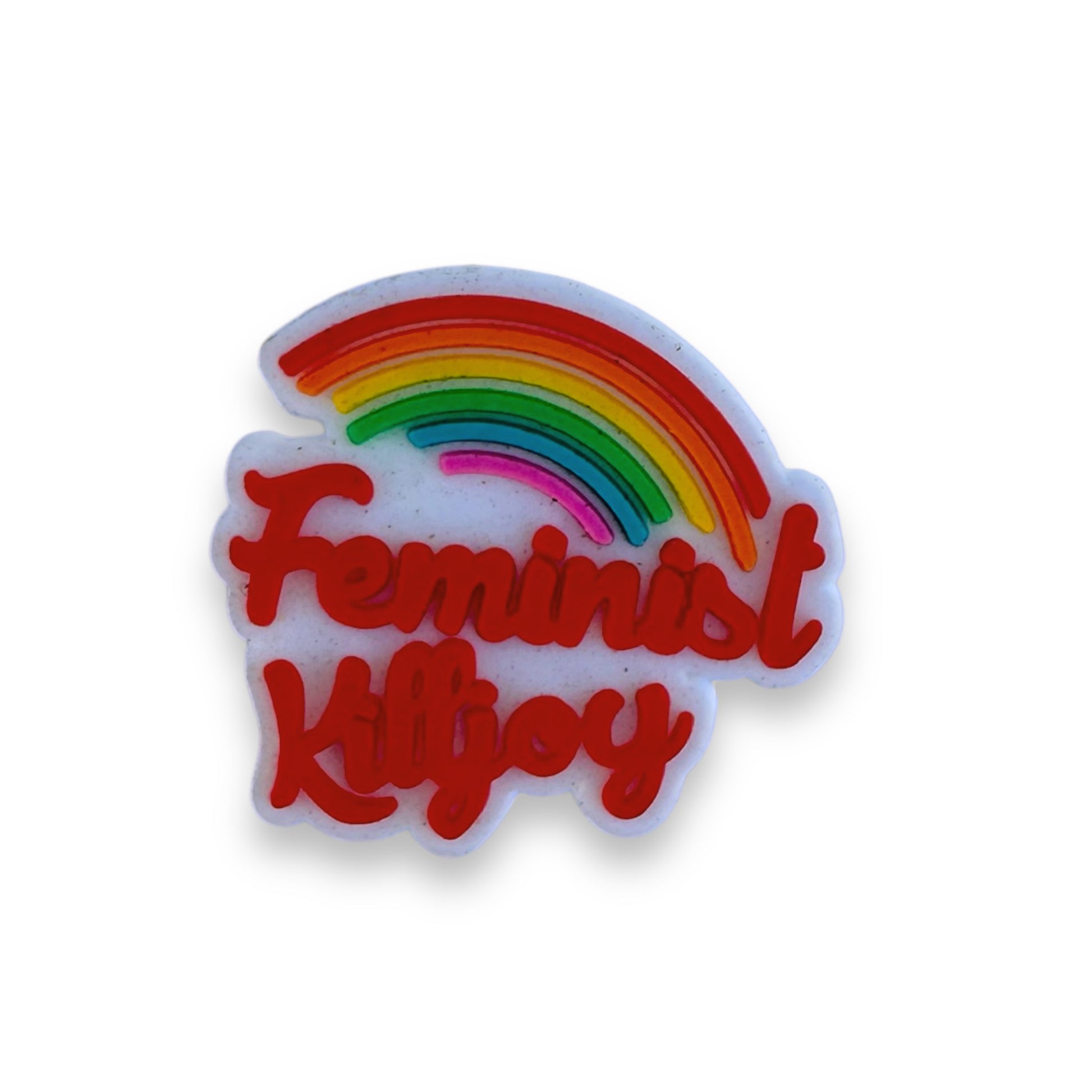 Clog charm with Feminist Killjoy written in red script beneath a tilted rainbow.