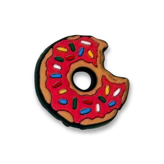 Cartoon donut clog charm with a bite out of it, with red icing and colored sprinkles.