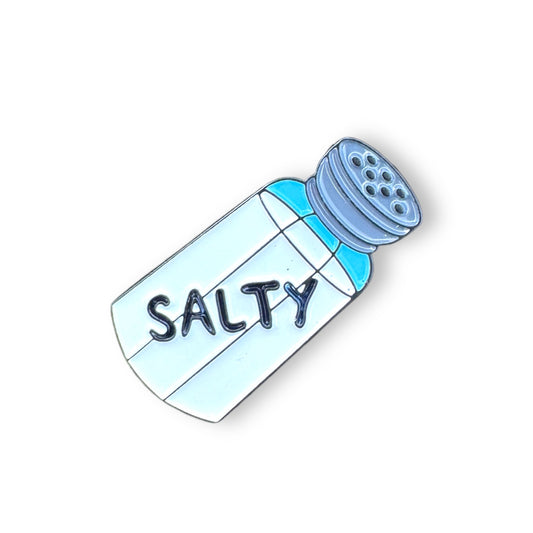 Salt shaker shaped lapel pin with the word Salty written on it.