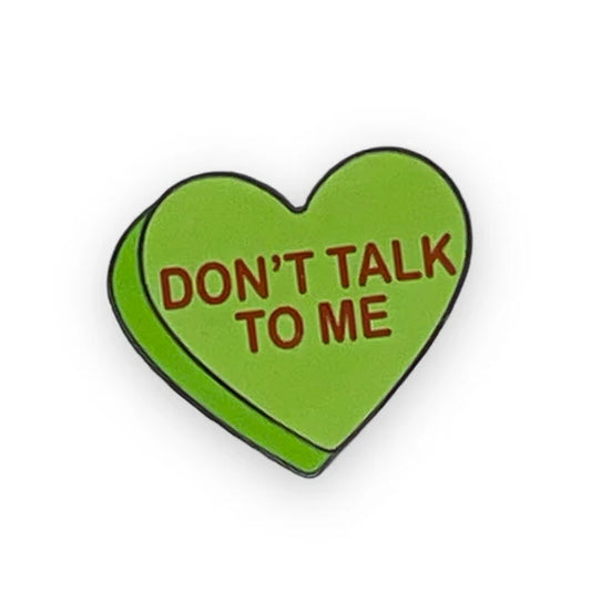 Green heart-shaped pin with the words: DON'T TALK TO ME.