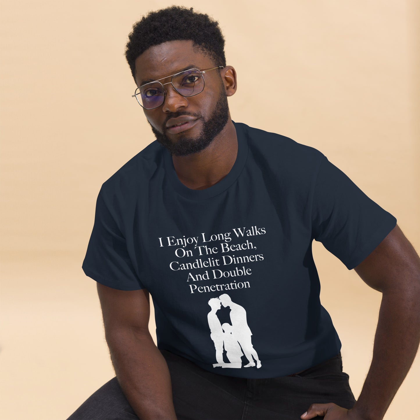 Navy T-shirt reads: I enjoy long walks on the beach, candlelit dinners and double penetration, above silhouette of three males in suggestive position.