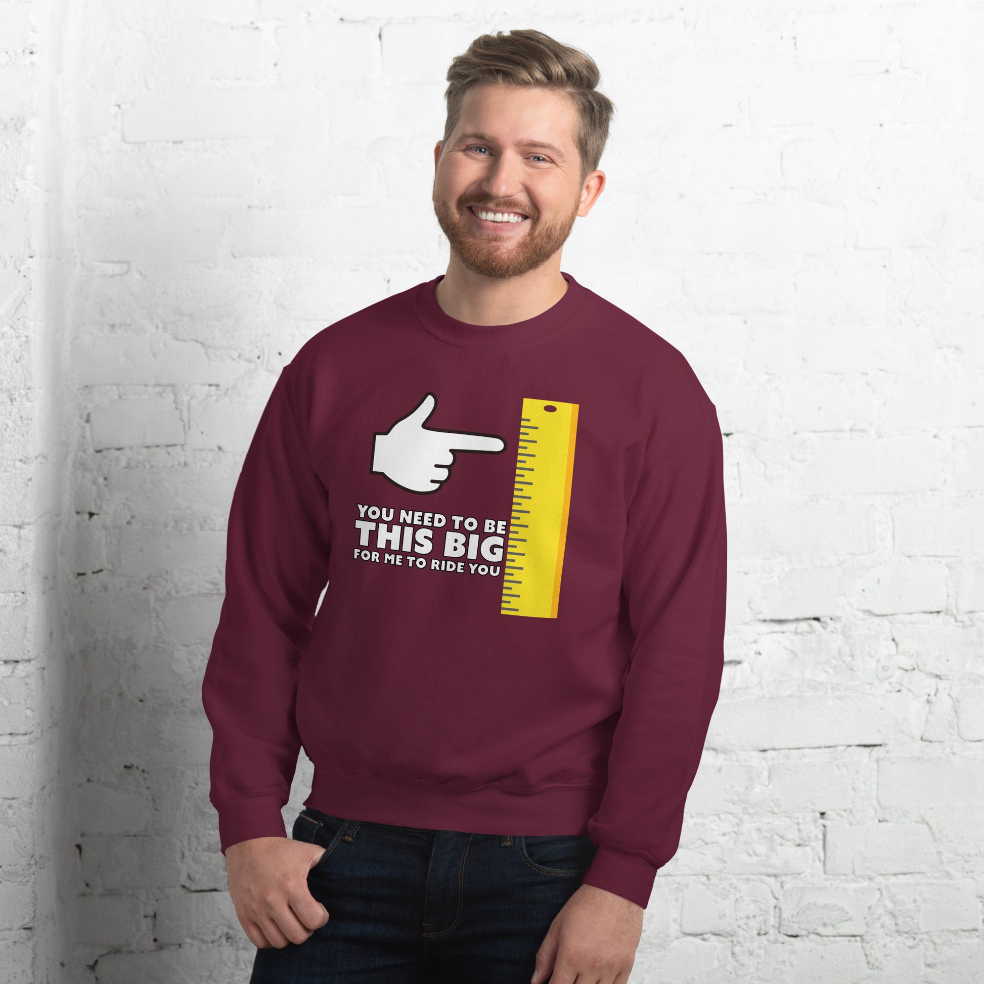 Man in maroon shirt. You need to be this big for me to ride you, with cartoon hand pointing at the vertical yellow ruler.